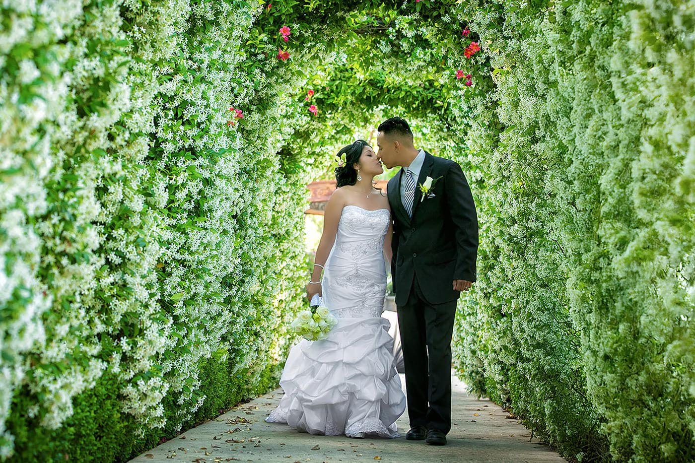 Wedding Videography Los Angeles - Garden floral arch wedding kiss by IMAGE369